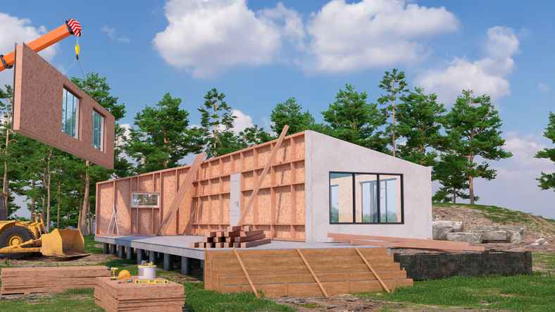 A modular home being pieced together on a construction site